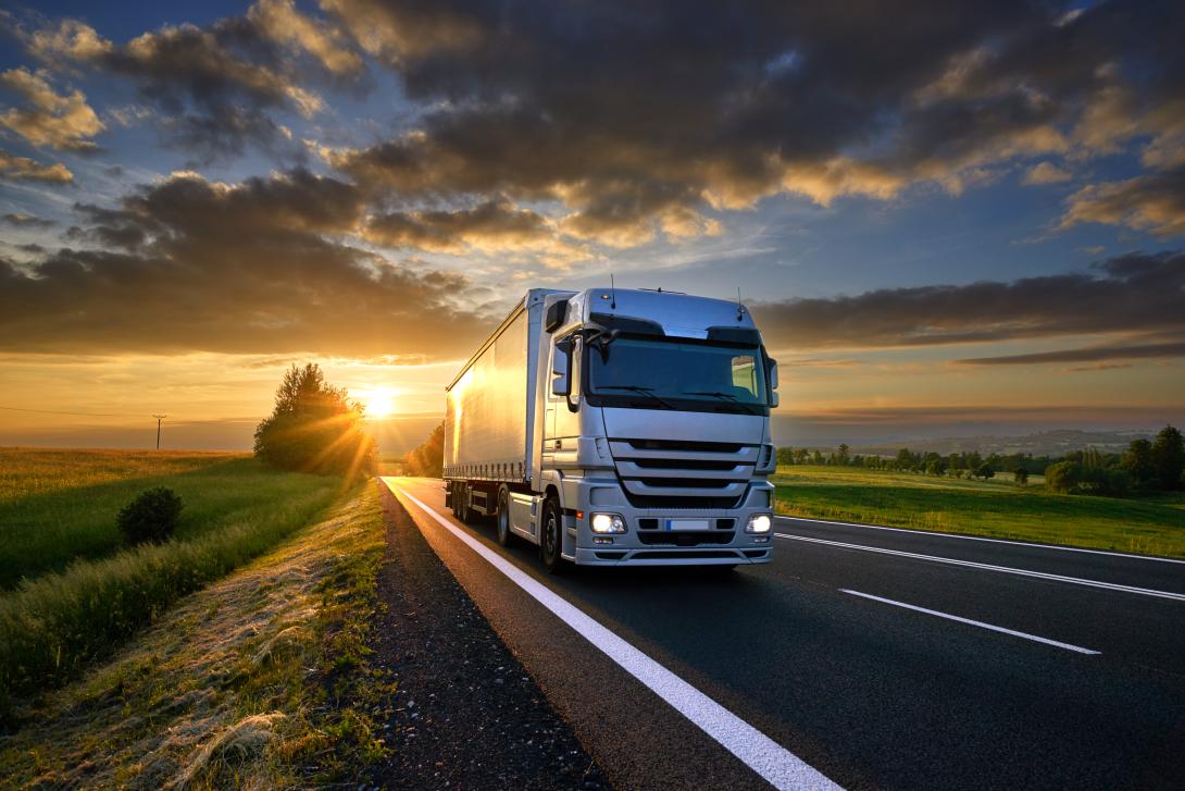 Truck on road with sunset